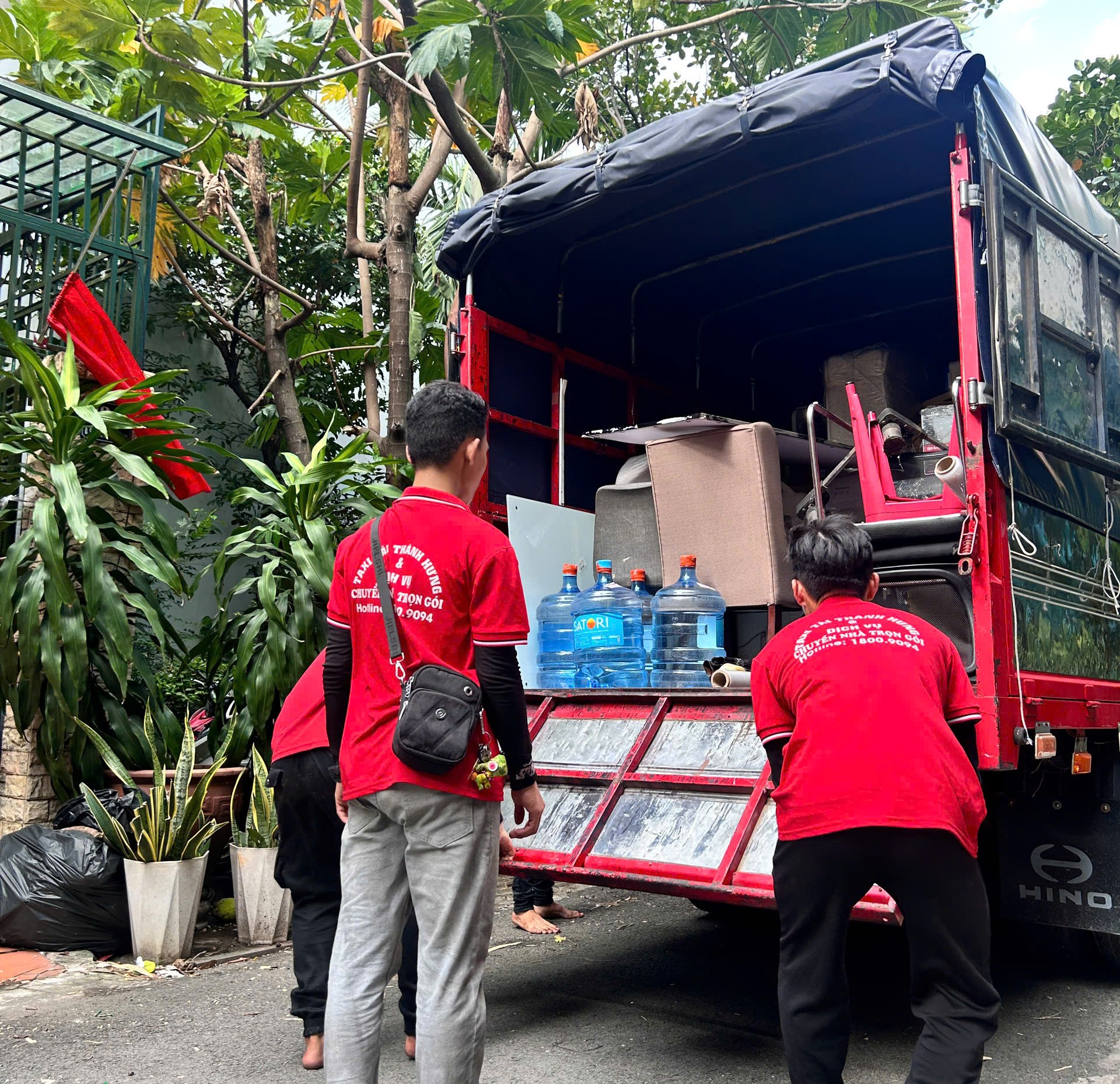 Nhân viên Thành Hưng bọc màng và khiêng tủ gỗ khi chuyển nhà